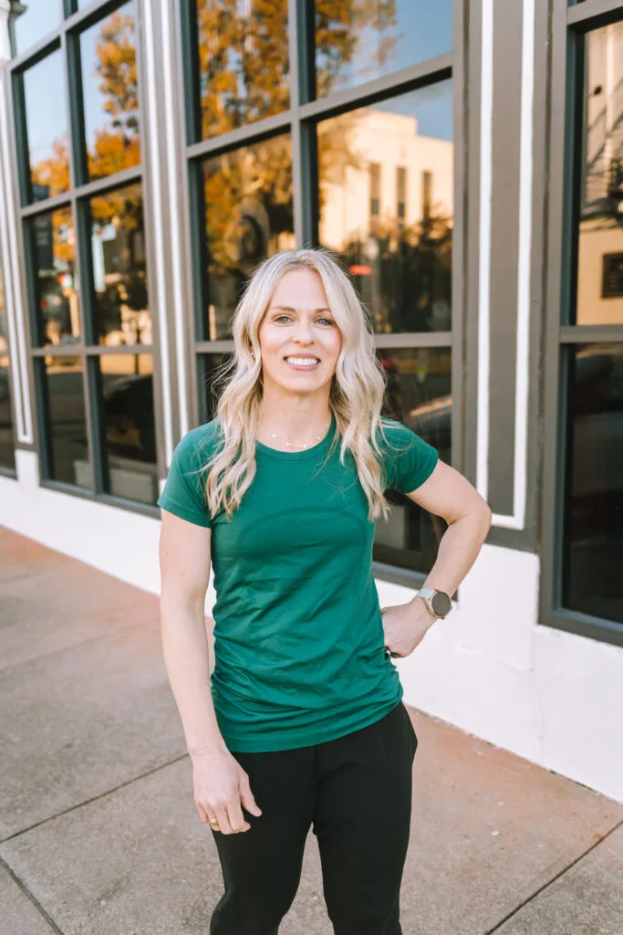 Jena Brown dietitian wearing teal short sleeve top walking on sidewalk